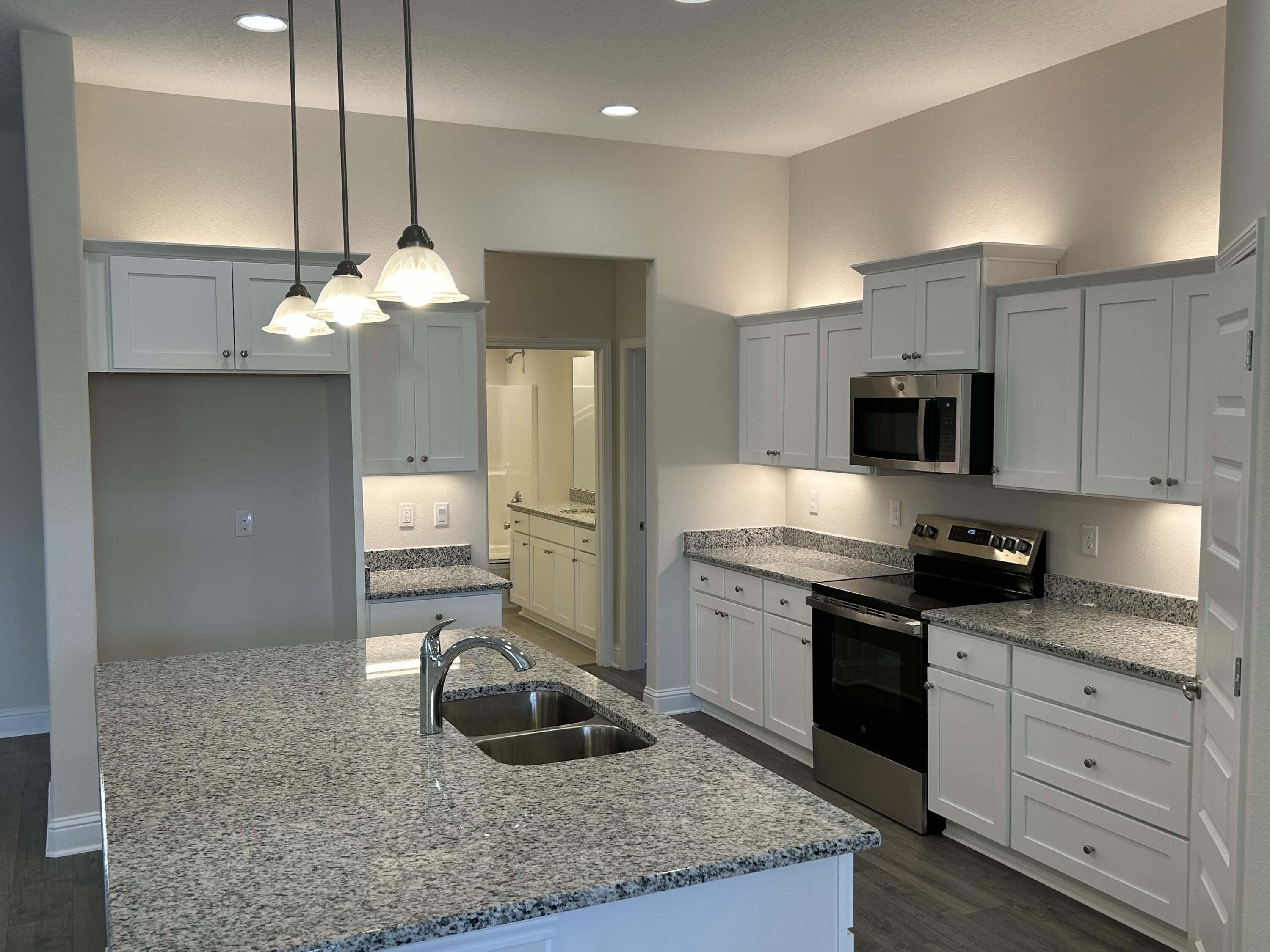 6615 Angle Road, Unit HBTS 5112 Navarre, FL 32566 - Photo 16 of 36 a kitchen with stainless steel appliances granite countertop a sink a stove and a refrigerator