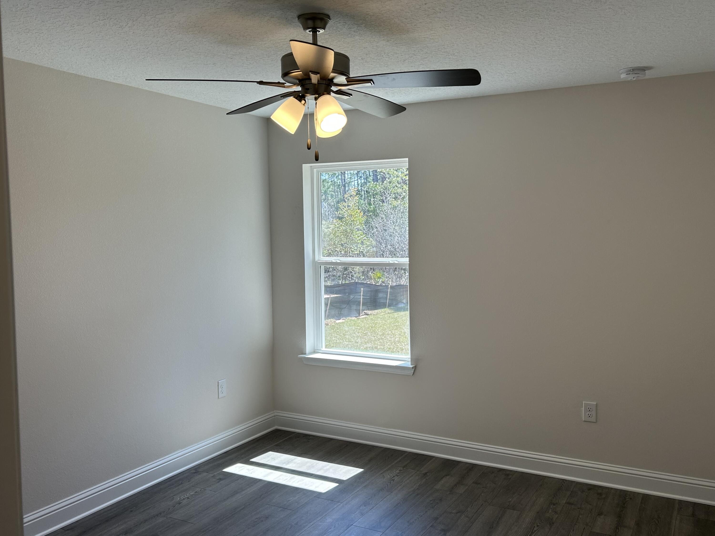 6615 Angle Road, Unit HBTS 5112 Navarre, FL 32566 - Photo 20 of 36 a view of an empty room with wooden floor and a window