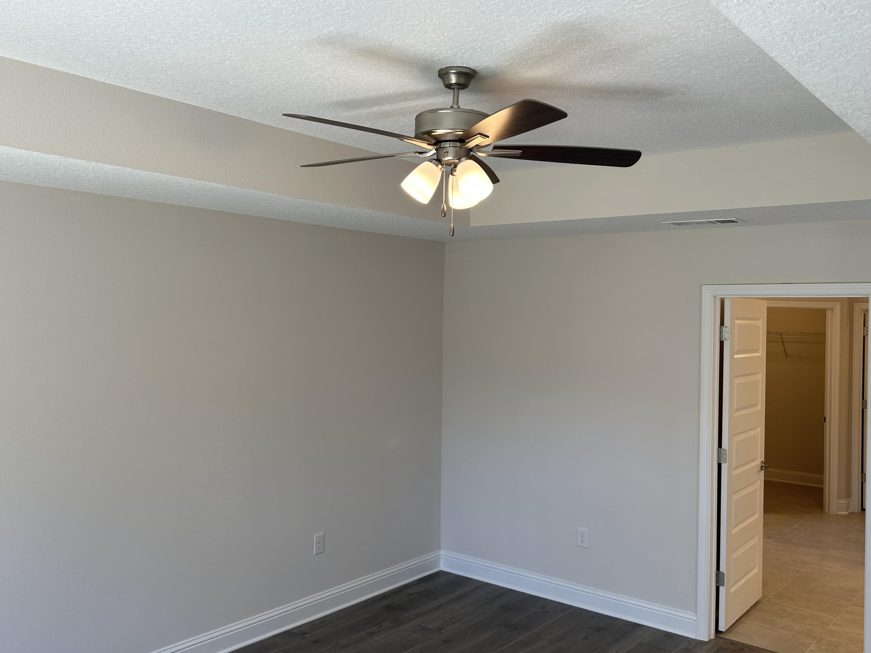 6615 Angle Road, Unit HBTS 5112 Navarre, FL 32566 - Photo 24 of 36 a view of a chandelier fan and wooden floor