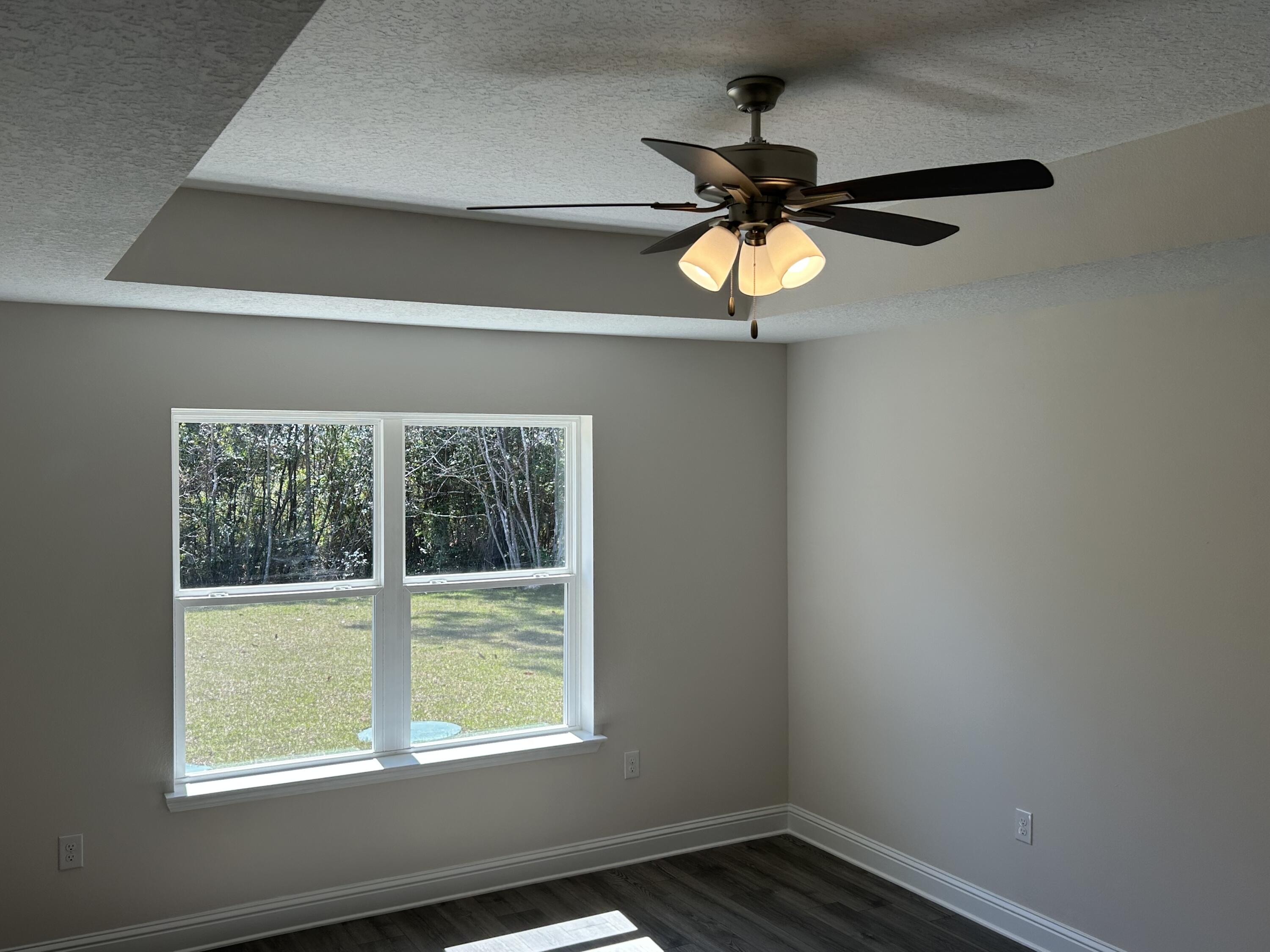 6615 Angle Road, Unit HBTS 5112 Navarre, FL 32566 - Photo 25 of 36 a view of an empty room with wooden floor and a window