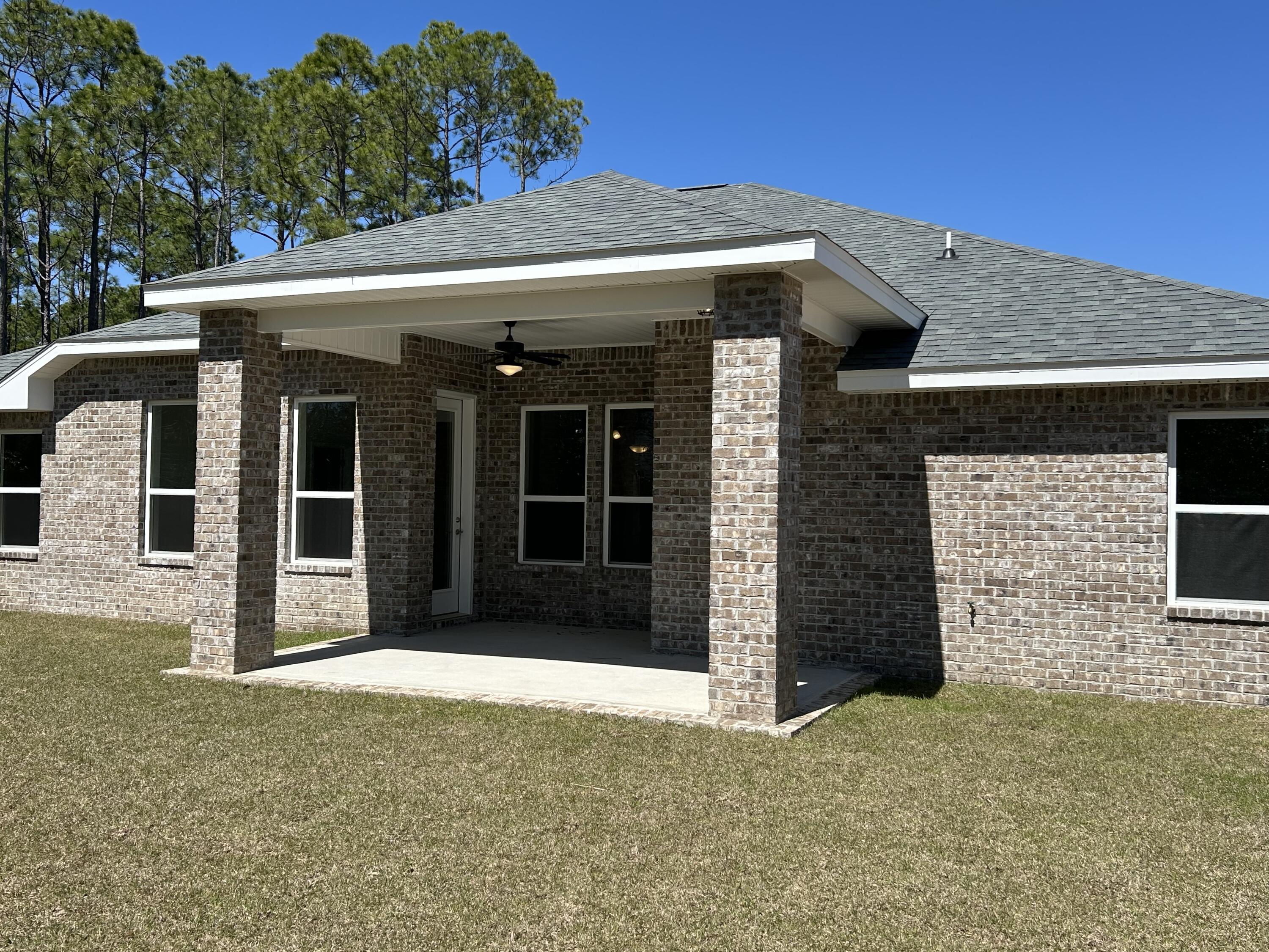 6615 Angle Road, Unit HBTS 5112 Navarre, FL 32566 - Photo 34 of 36 a front view of a house with a garage