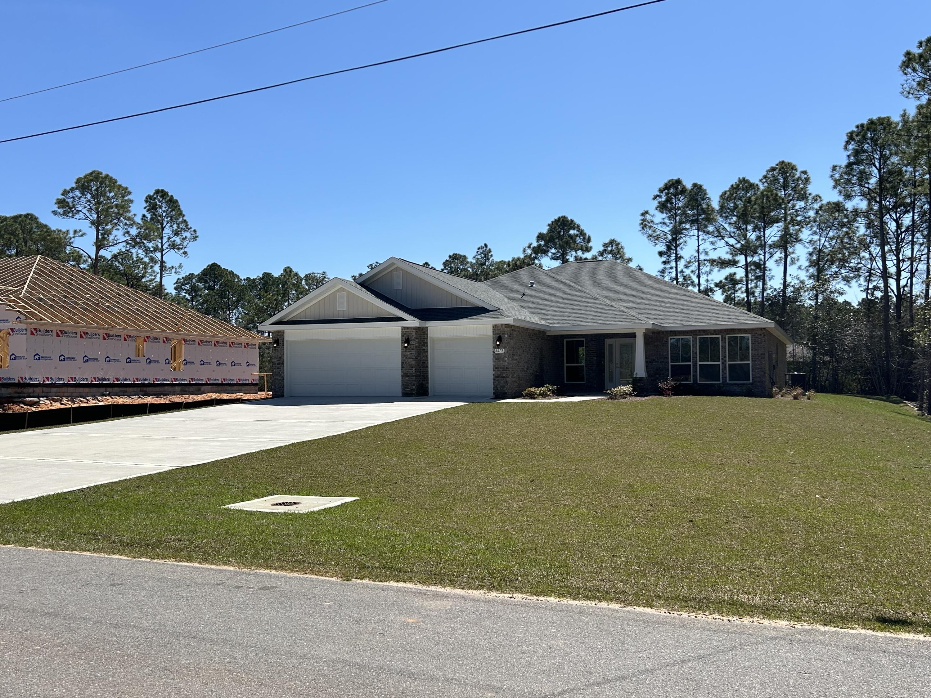 6615 Angle Road, Unit HBTS 5112 Navarre, FL 32566 - Photo 4 of 36 a front view of a house with a yard