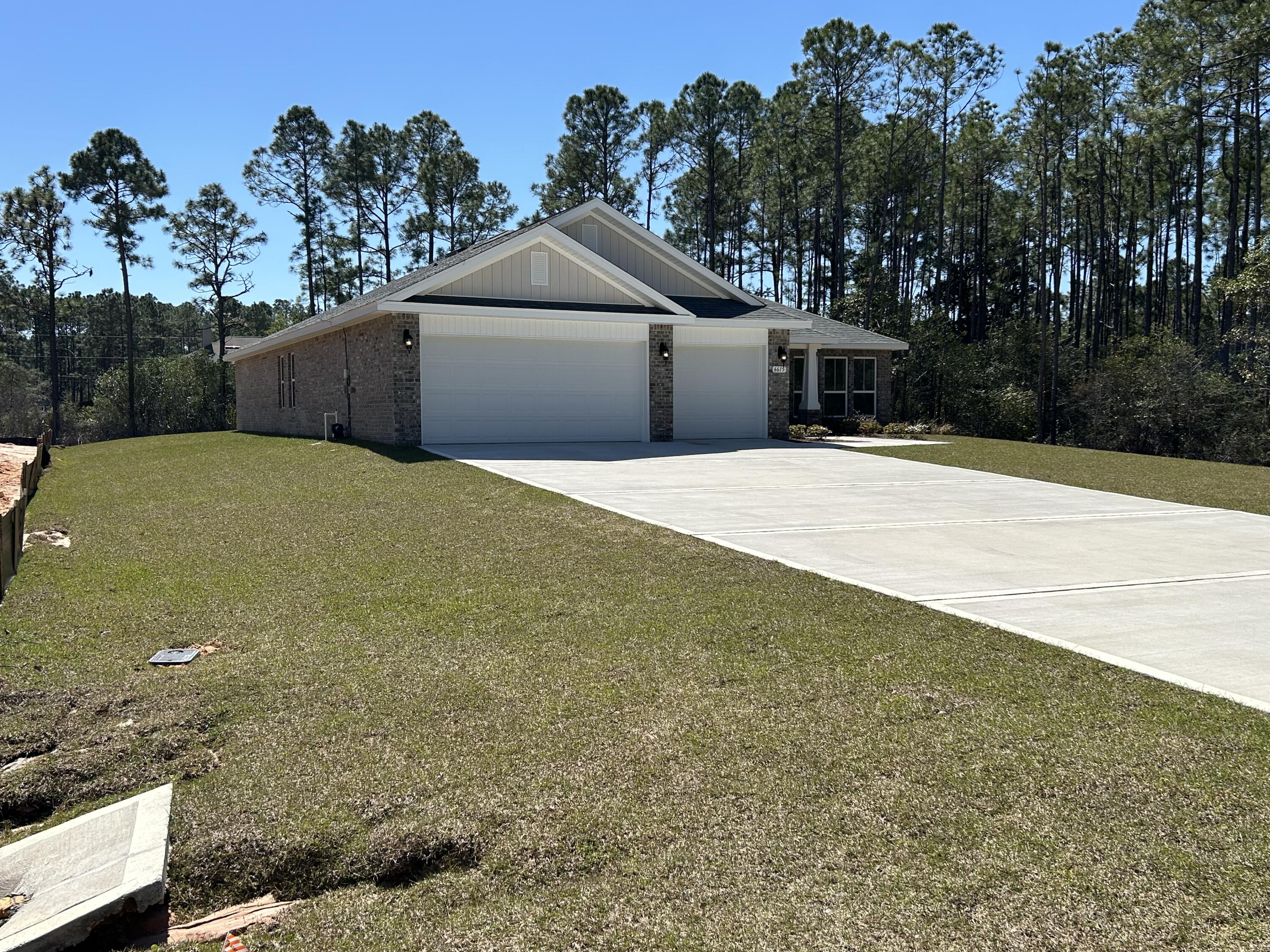 6615 Angle Road, Unit HBTS 5112 Navarre, FL 32566 - Photo 5 of 36 a front view of a house with a yard and garage