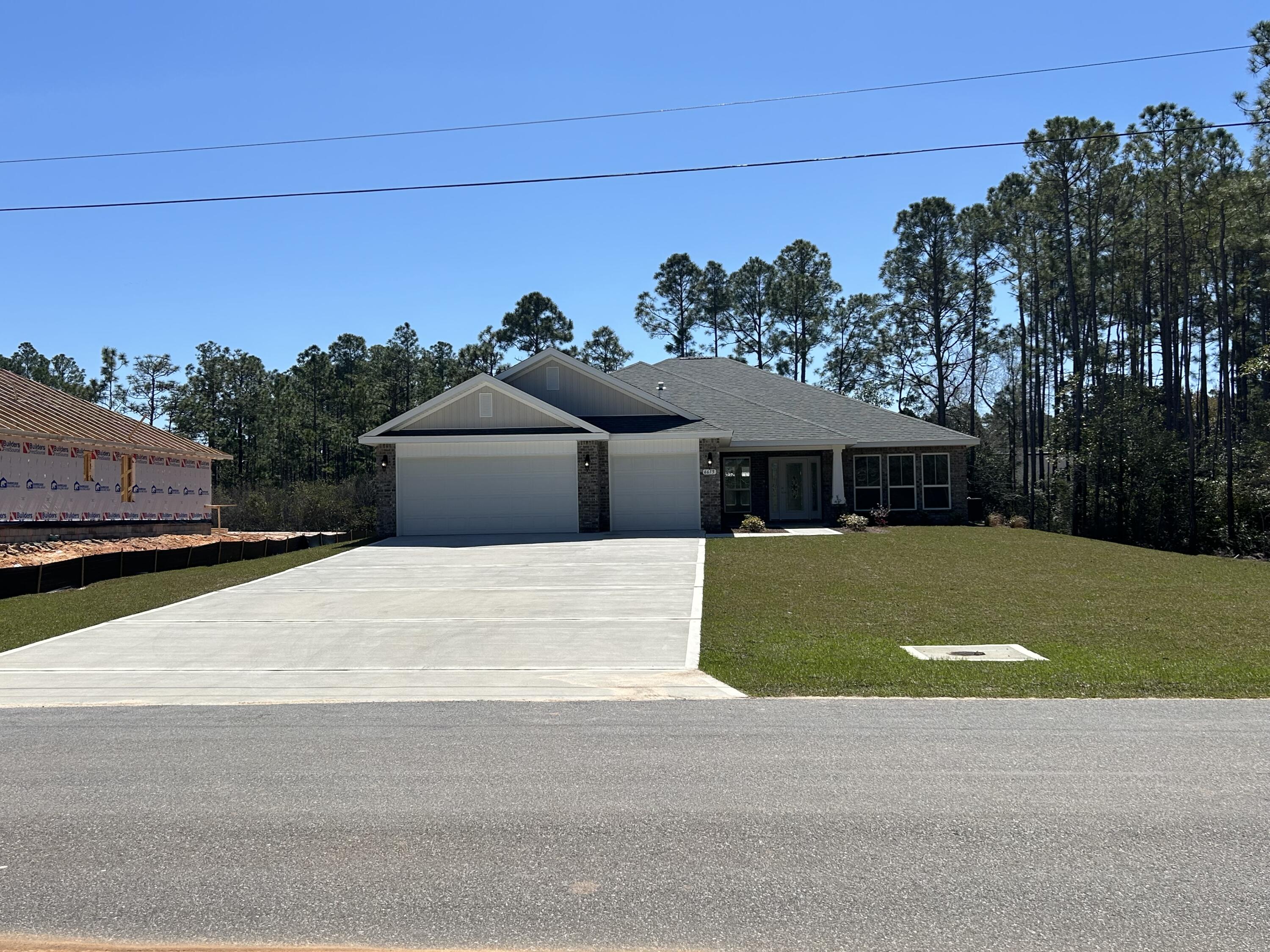 6615 Angle Road, Unit HBTS 5112 Navarre, FL 32566 - Photo 6 of 36 a front view of a house with a yard and garage