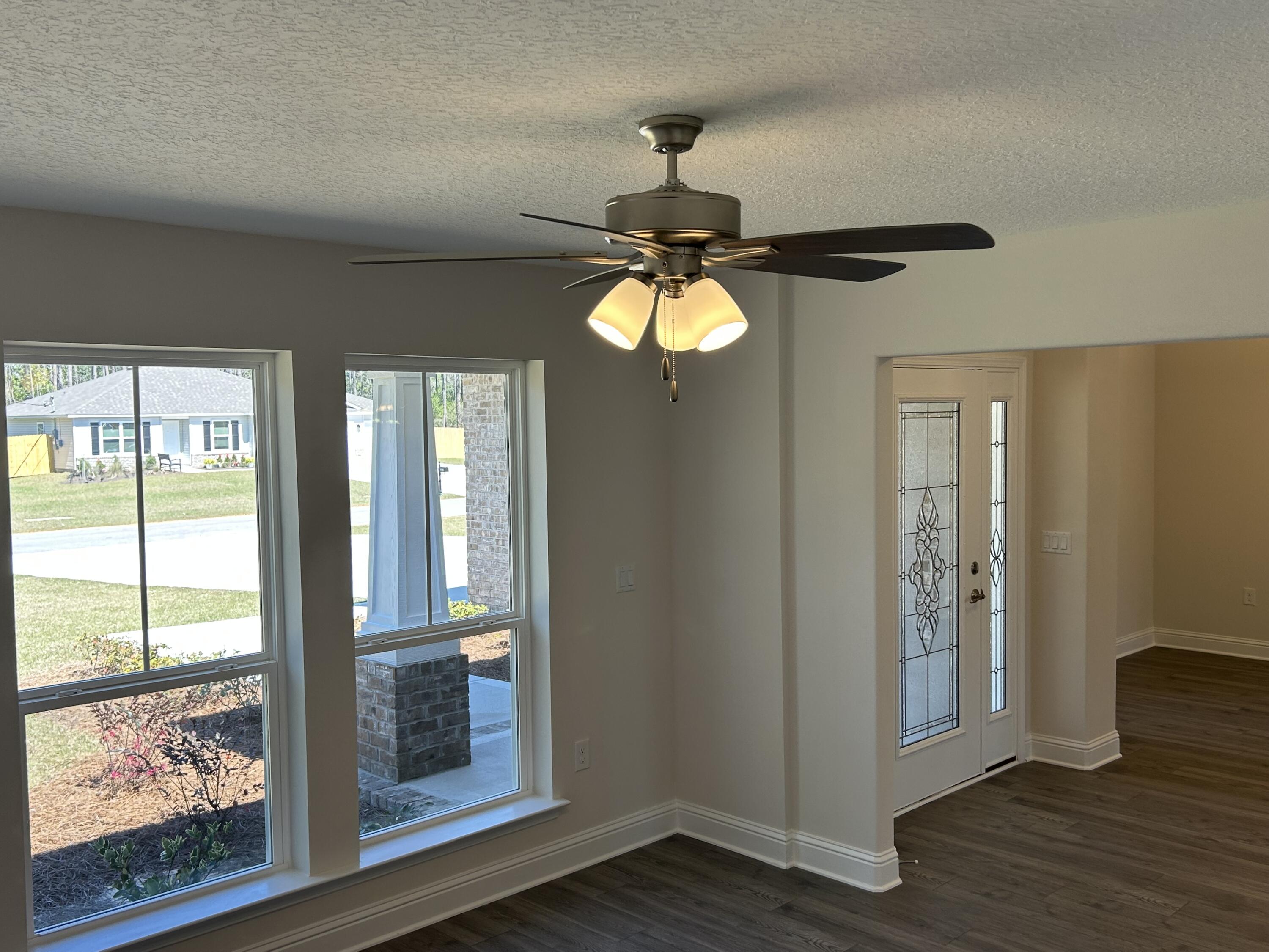 6615 Angle Road, Unit HBTS 5112 Navarre, FL 32566 - Photo 7 of 36 a view of a chandelier fan and wooden floor in a room