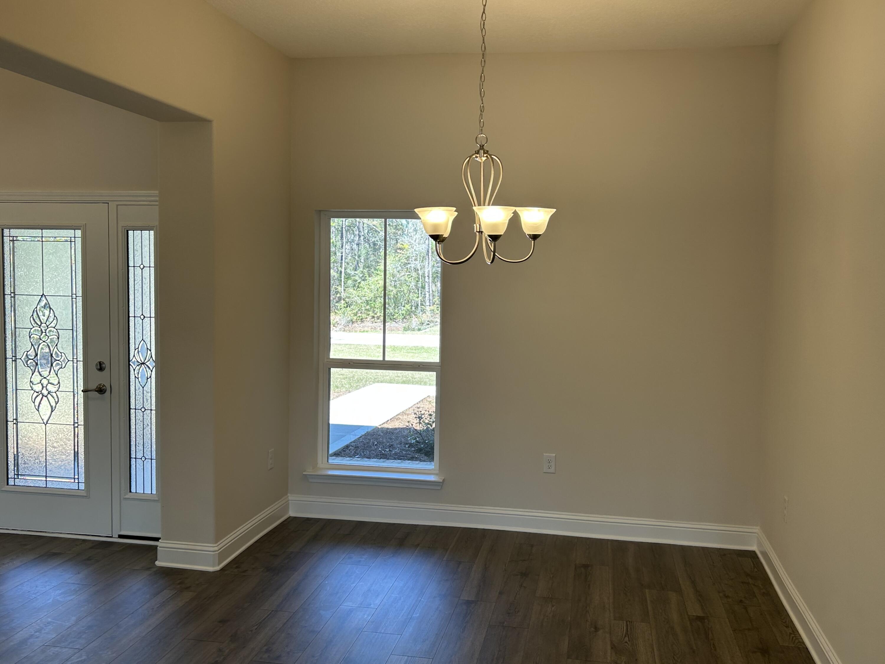 6615 Angle Road, Unit HBTS 5112 Navarre, FL 32566 - Photo 10 of 36 an empty room with wooden floor fan and window
