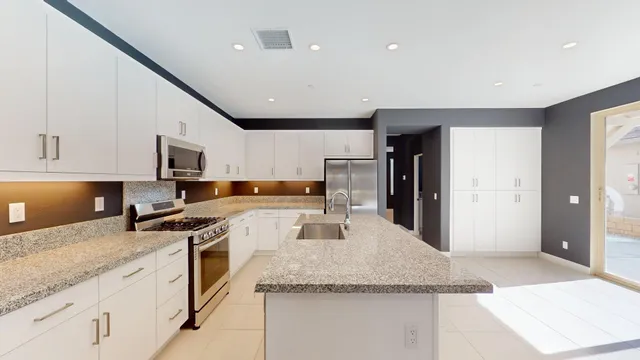 a kitchen with refrigerator and cabinets