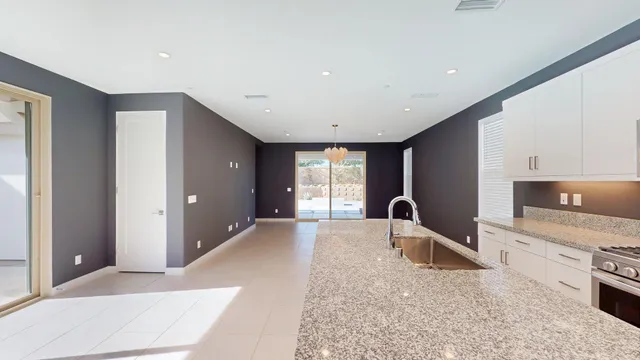 a kitchen with a sink and chandelier