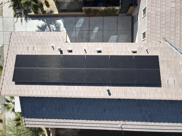 an aerial view of a house with swimming pool and porch
