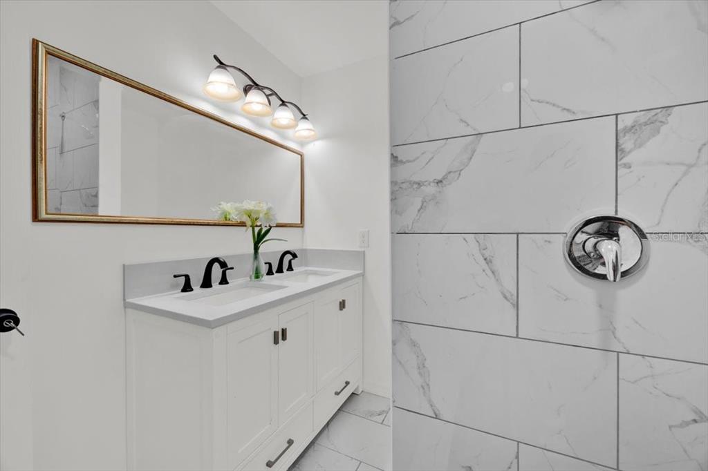 2930 Rio Lane Orlando, FL 32805 - Photo 13 of 28 a bathroom with a sink and mirror