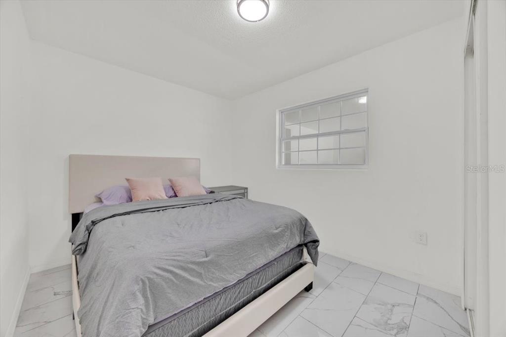 2930 Rio Lane Orlando, FL 32805 - Photo 14 of 28 a bedroom with a bed and window