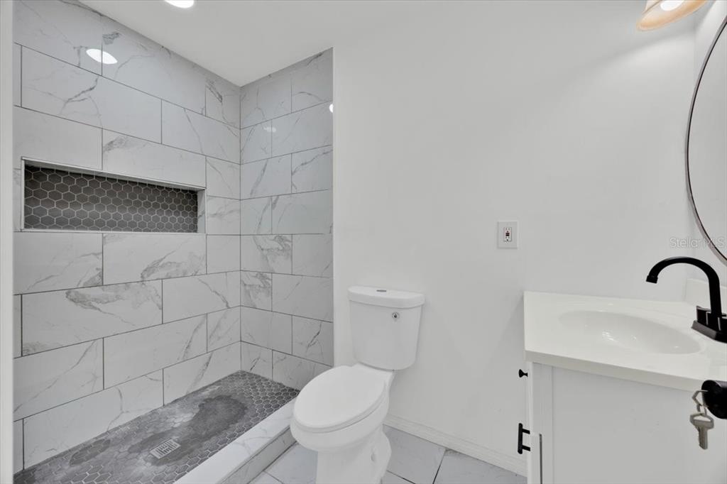 2930 Rio Lane Orlando, FL 32805 - Photo 15 of 28 a bathroom with a shower a toilet and a sink