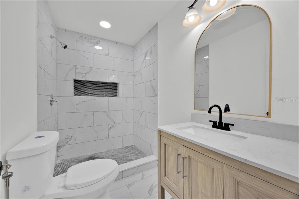 2930 Rio Lane Orlando, FL 32805 - Photo 17 of 28 a bathroom with a sink a toilet and shower