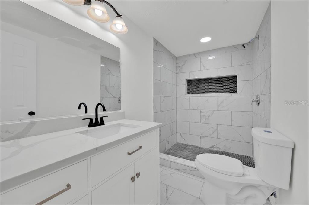 2930 Rio Lane Orlando, FL 32805 - Photo 25 of 28 a bathroom with a toilet a sink and mirror