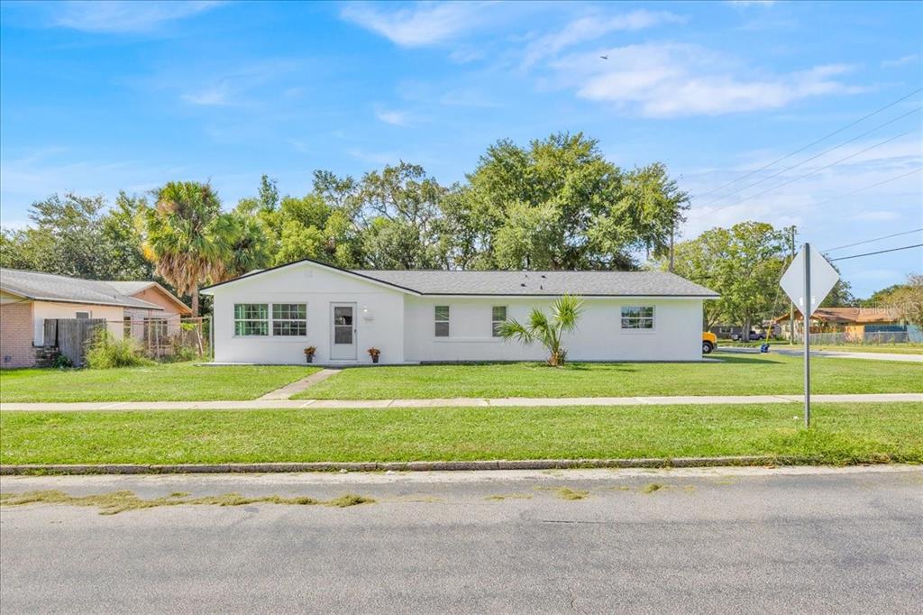 2930 Rio Lane Orlando, FL 32805 - Photo 3 of 28 a front view of a house with a yard and trees
