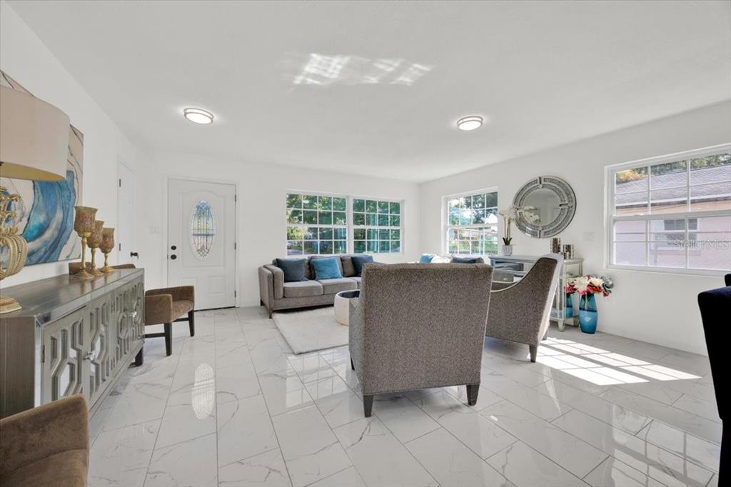2930 Rio Lane Orlando, FL 32805 - Photo 6 of 28 a living room filled with furniture chandelier and a large window