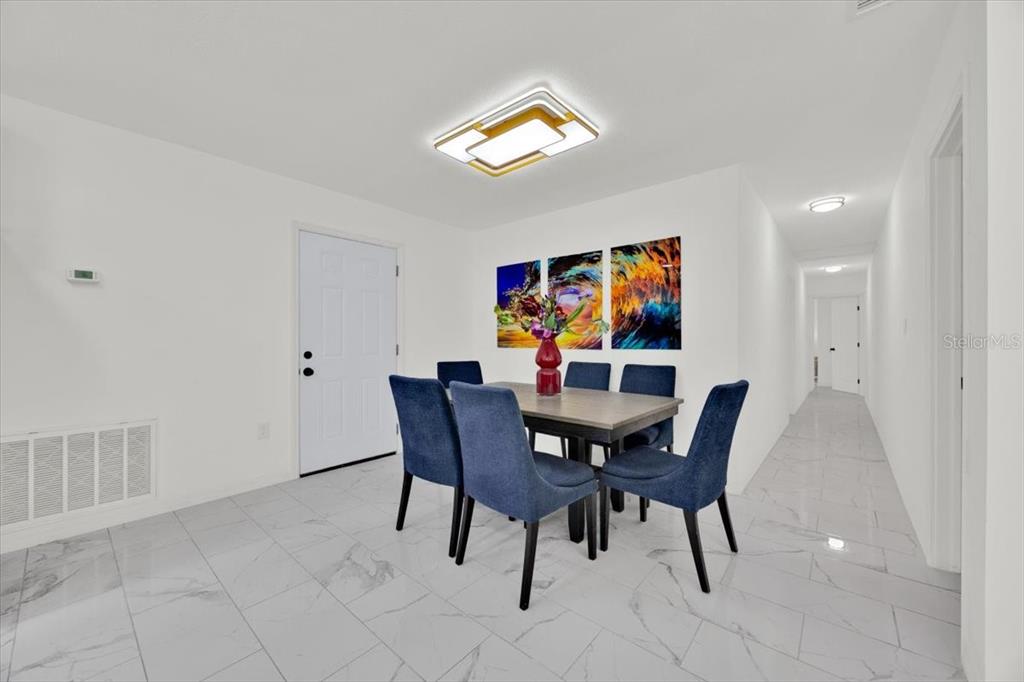 2930 Rio Lane Orlando, FL 32805 - Photo 10 of 28 a view of a dining room with furniture and wooden floor