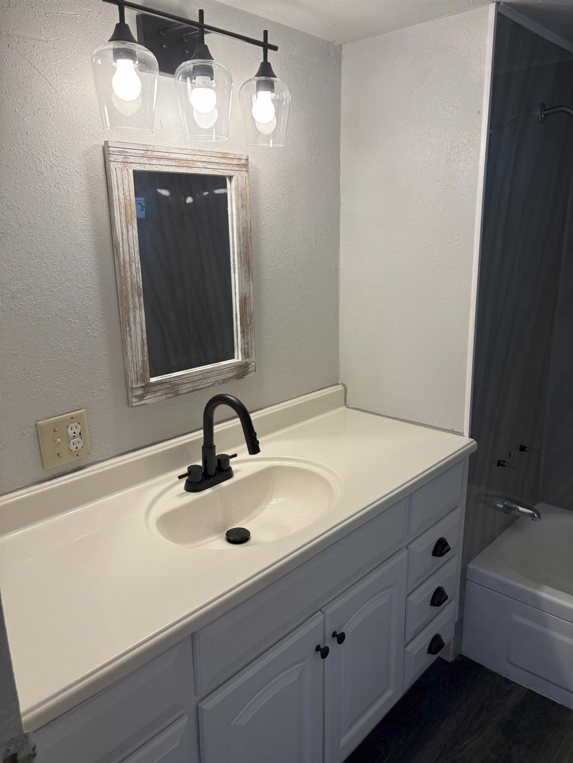 a bathroom with a sink a vanity and mirror