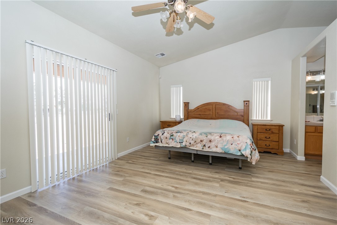 2381 Tough Boy Road Pahrump, NV 89060 - Photo 14 of 44 This spacious primary bedroom offers ample light and convenient access to an en-suite bath.