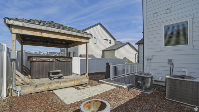 15008 South Springtime Road Draper, UT 84020 - Photo 5 of 37 Fenced backyard with a wooden deck, a gazebo, and a hot tub
