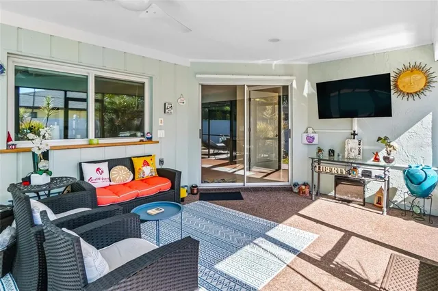 a living room with furniture large window and flat screen tv