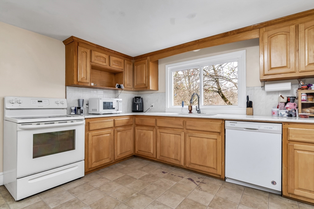 396 Oak Street Methuen, MA 01844 - Photo 11 of 42 a kitchen with granite countertop cabinets stainless steel appliances a sink and a window