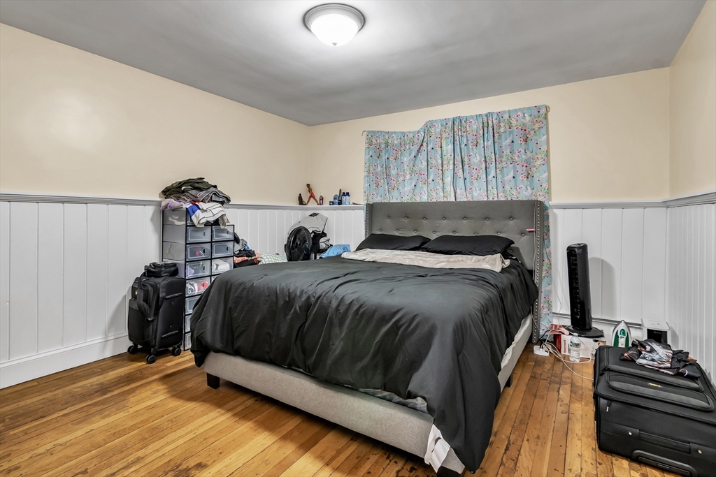 396 Oak Street Methuen, MA 01844 - Photo 15 of 42 a bedroom with a bed and wooden floor