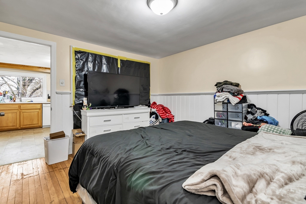 396 Oak Street Methuen, MA 01844 - Photo 16 of 42 a bedroom with a bed and a flat tv screen on the dresser
