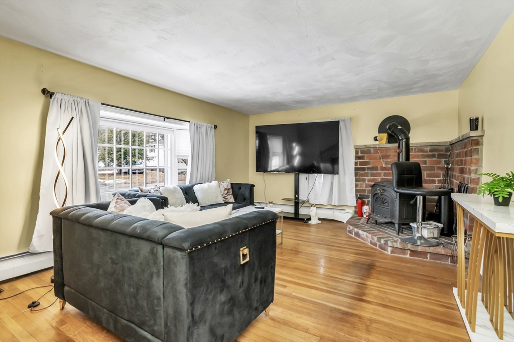 396 Oak Street Methuen, MA 01844 - Photo 19 of 42 a living room with fireplace furniture and a flat screen tv