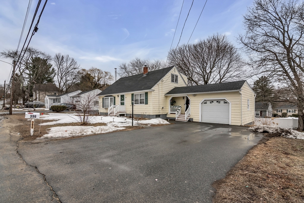 396 Oak Street Methuen, MA 01844 - Photo 2 of 42 a front view of a house with a yard and garage