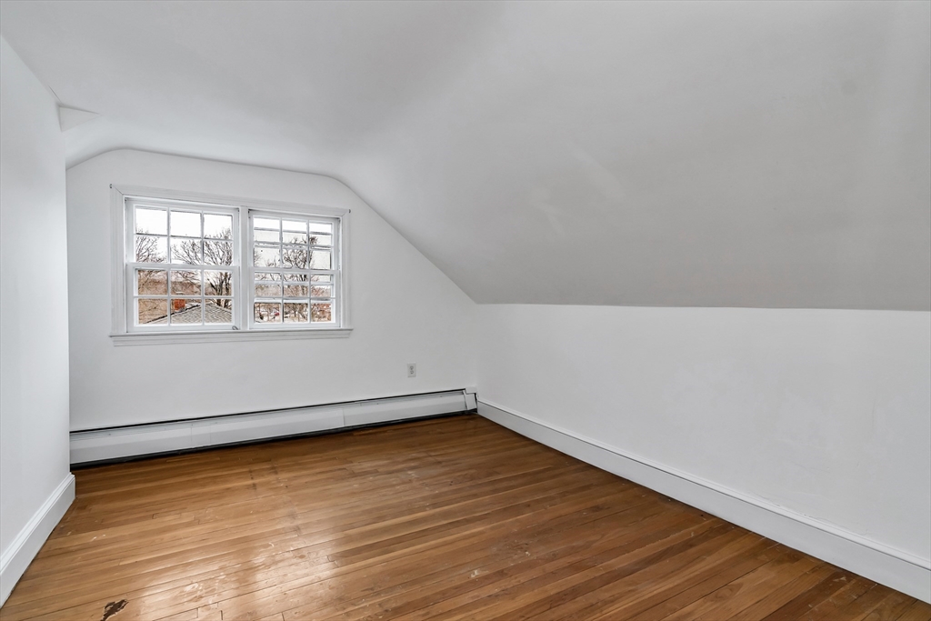 396 Oak Street Methuen, MA 01844 - Photo 25 of 42 an empty room with wooden floor and windows