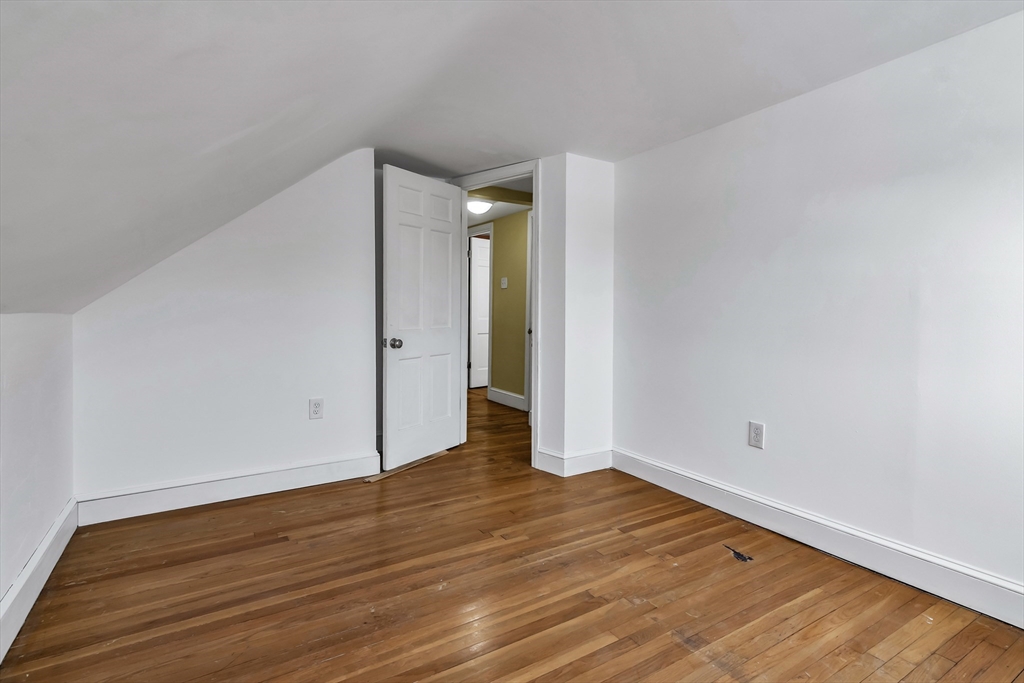 396 Oak Street Methuen, MA 01844 - Photo 27 of 42 a view of an empty room with wooden floor