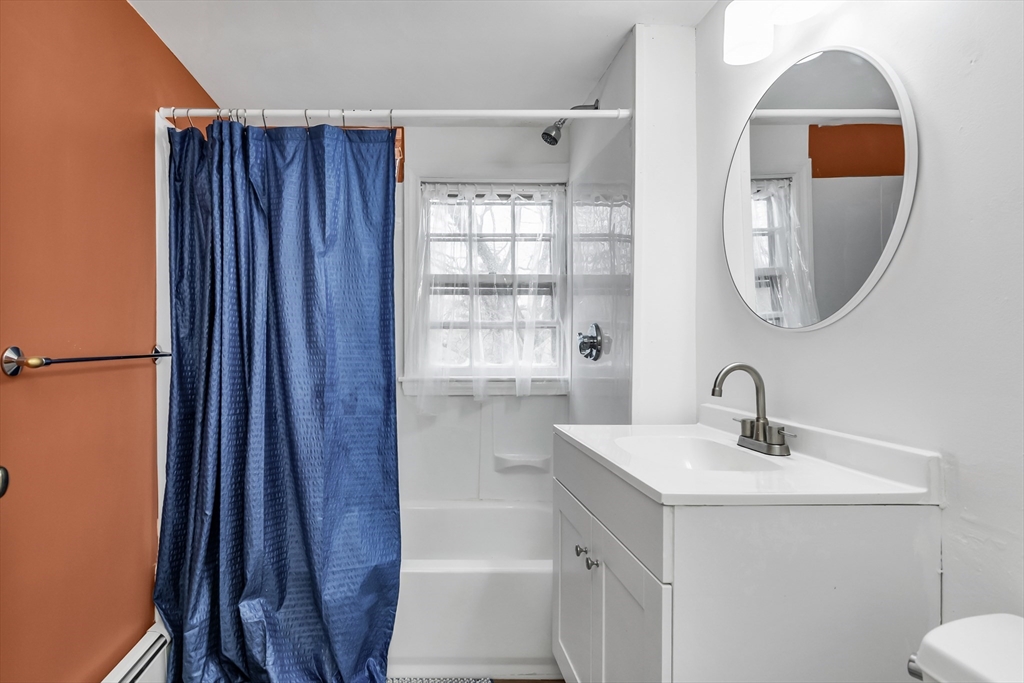 396 Oak Street Methuen, MA 01844 - Photo 29 of 42 a bathroom with a sink a toilet and a mirror