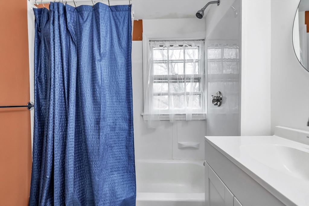 396 Oak Street Methuen, MA 01844 - Photo 30 of 42 a bathroom with a bathtub and a shower