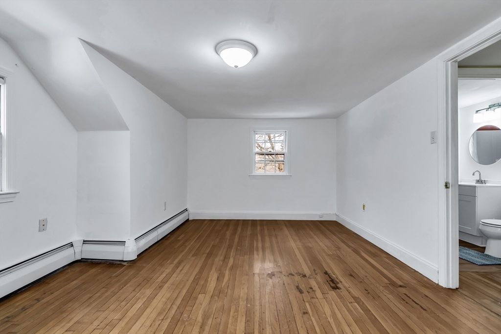 396 Oak Street Methuen, MA 01844 - Photo 32 of 42 an empty room with wooden floor and windows