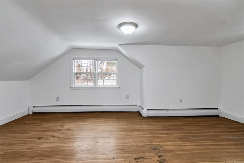 396 Oak Street Methuen, MA 01844 - Photo 33 of 42 an empty room with wooden floor and windows