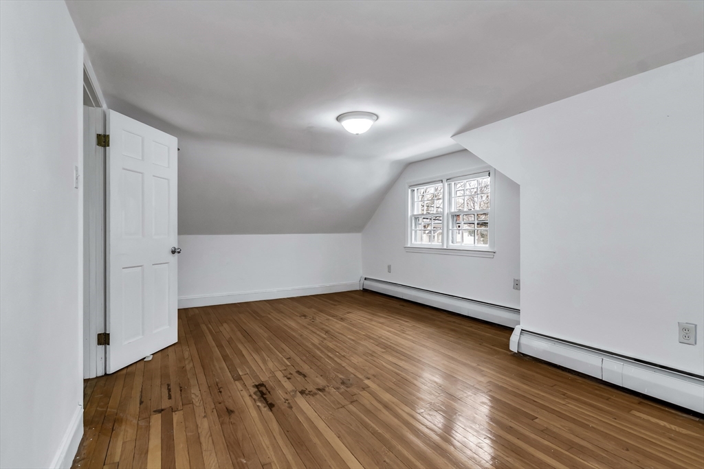 396 Oak Street Methuen, MA 01844 - Photo 34 of 42 an empty room with wooden floor and windows