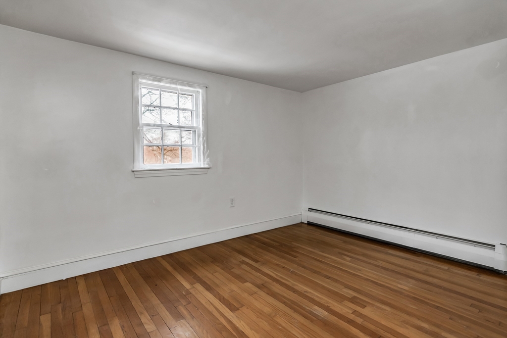 396 Oak Street Methuen, MA 01844 - Photo 35 of 42 an empty room with wooden floor and windows