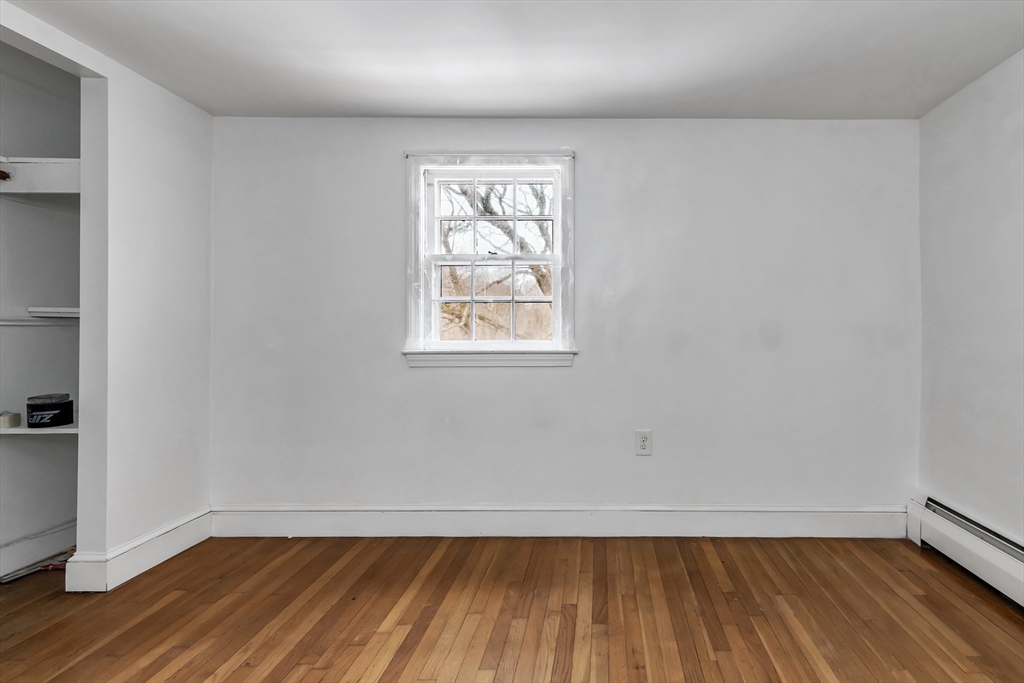 396 Oak Street Methuen, MA 01844 - Photo 36 of 42 an empty room with wooden floor and windows