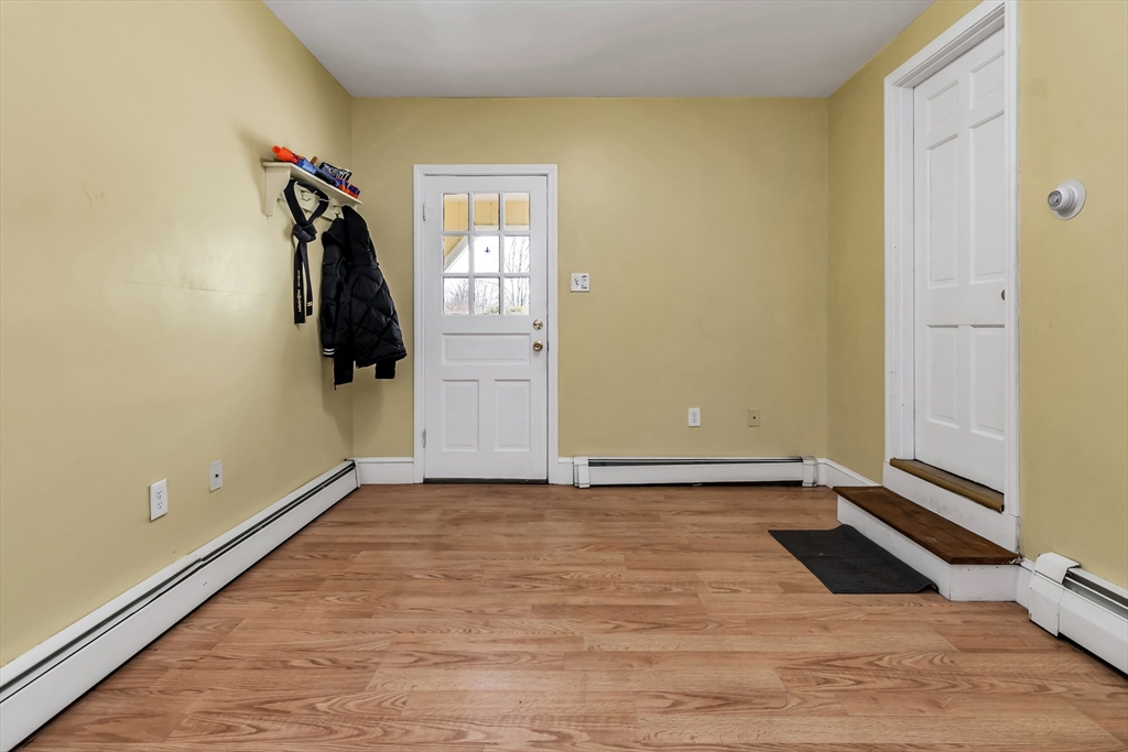 396 Oak Street Methuen, MA 01844 - Photo 5 of 42 a view of a room with a wooden floor and a cabinet