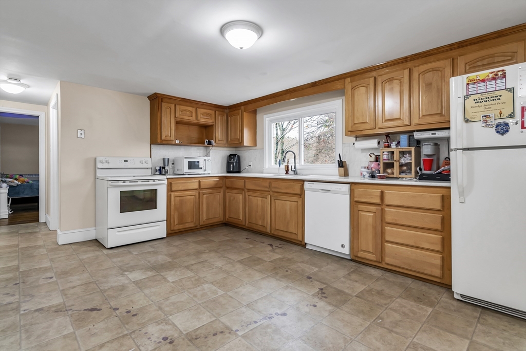 396 Oak Street Methuen, MA 01844 - Photo 8 of 42 a kitchen with white cabinets stainless steel appliances and sink
