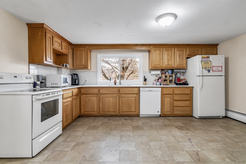 396 Oak Street Methuen, MA 01844 - Photo 10 of 42 a kitchen with a stove top oven sink and cabinets