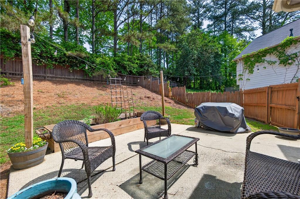 3904 Keystone Ridge Acworth, GA 30101 - Photo 15 of 45 a view of a patio with couches chairs and a fire pit