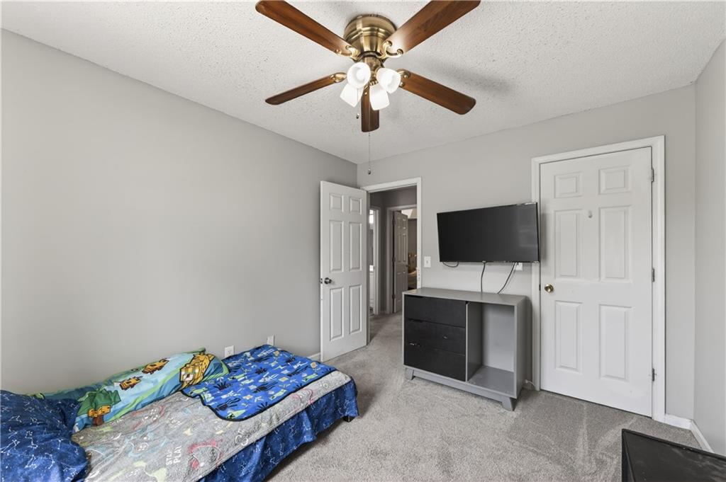 3904 Keystone Ridge Acworth, GA 30101 - Photo 18 of 45 a bedroom with a bed and a flat screen tv