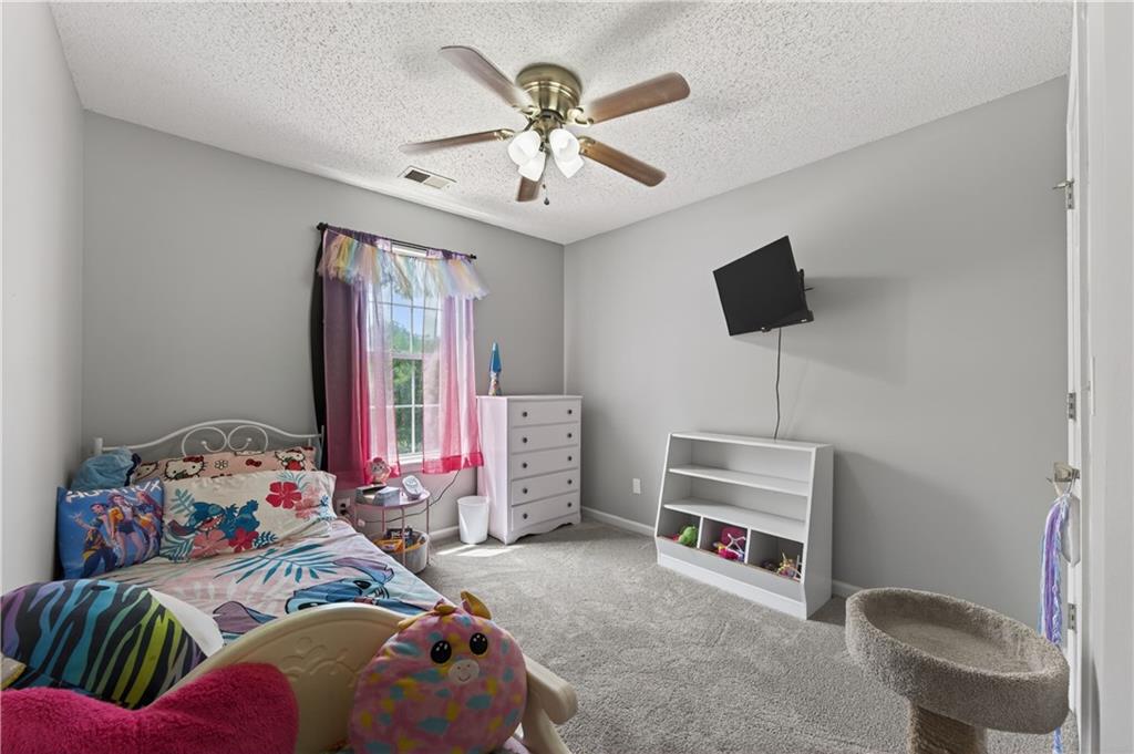 3904 Keystone Ridge Acworth, GA 30101 - Photo 20 of 45 a bedroom with a bed and a chandelier