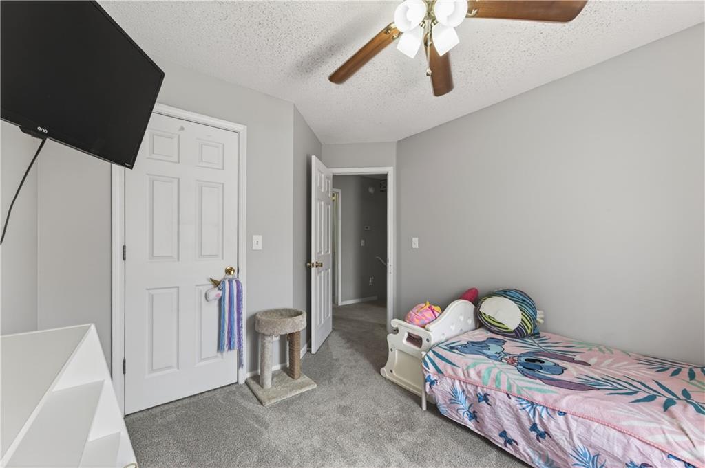 3904 Keystone Ridge Acworth, GA 30101 - Photo 21 of 45 a bedroom with a bed and a chandelier