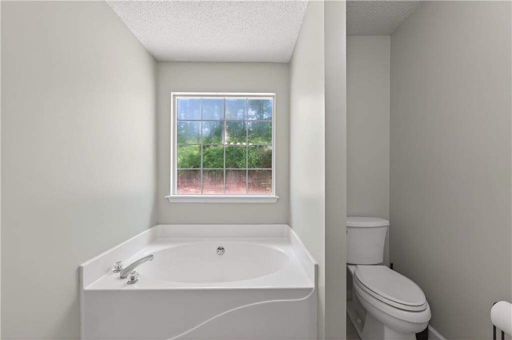 3904 Keystone Ridge Acworth, GA 30101 - Photo 23 of 45 a white bath tub sitting next to a toilet