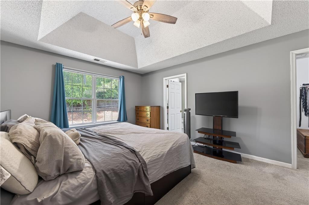 3904 Keystone Ridge Acworth, GA 30101 - Photo 26 of 45 a bedroom with a bed and a flat screen tv