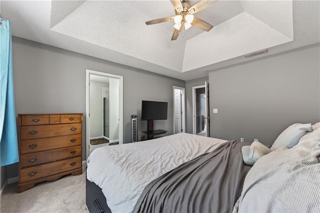 3904 Keystone Ridge Acworth, GA 30101 - Photo 27 of 45 a bedroom with a large bed and a chandelier