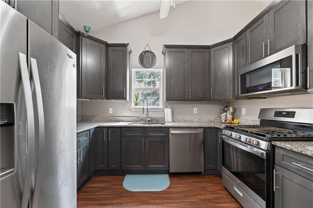 3904 Keystone Ridge Acworth, GA 30101 - Photo 30 of 45 a kitchen with stainless steel appliances granite countertop a stove a sink dishwasher a refrigerator and a microwave oven